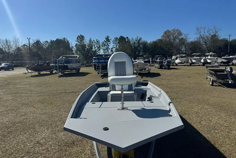 Slide: The Image of 2026 G3 Bay 17 boat displayed outdoors, surrounded by other boats under a clear blue sky. - 8