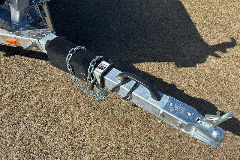 Slide: The Image of Trailer hitch of 2026 G3 Sportsman 1710 with chain lock on grass. - 10