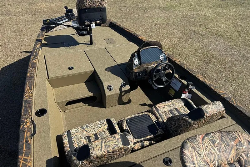 Slide: The Image of 2026 G3 Sportsman 1710 boat interior with camouflage seating and steering console. - 12