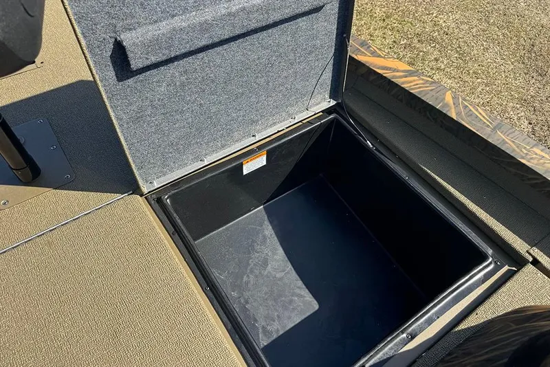 Slide: The Image of Open storage compartment on 2026 G3 Sportsman 1710 boat, featuring carpeted interior. - 16