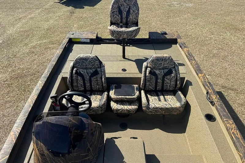 Slide: The Image of 2026 G3 Sportsman 1710 boat interior with camo seats and steering console. - 21
