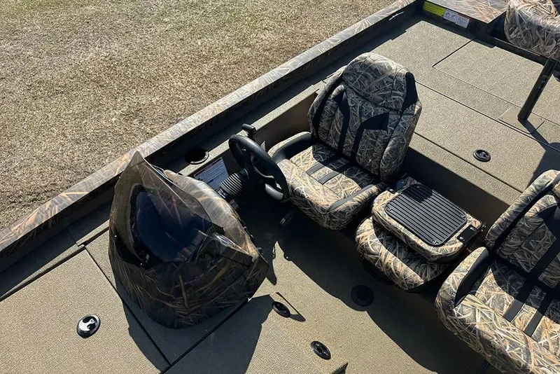 Slide: The Image of 2026 G3 Sportsman 1710 boat interior with camo seats and steering wheel. - 22