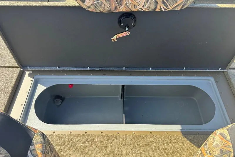 Slide: The Image of Open storage compartment in 2026 G3 Sportsman 1710 boat, featuring camo seating. - 28