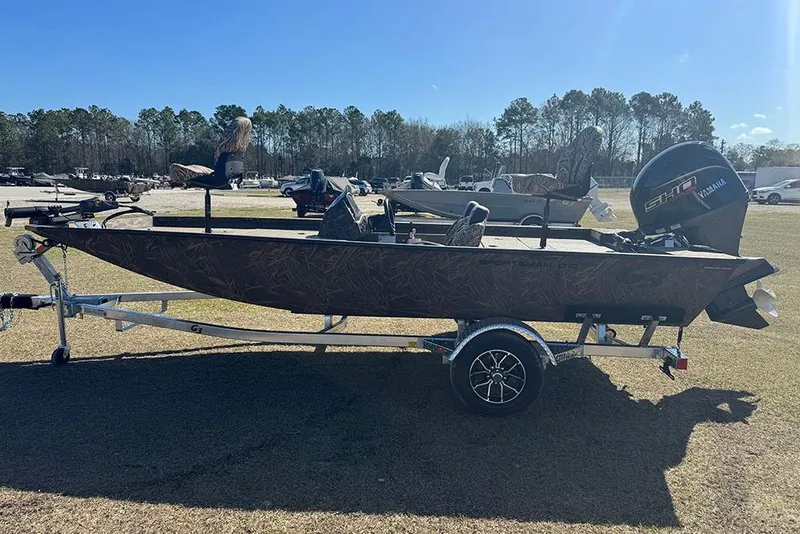 Slide: The Image of 2026 G3 Sportsman 1710 boat on trailer, parked outdoors under clear sky. - 7