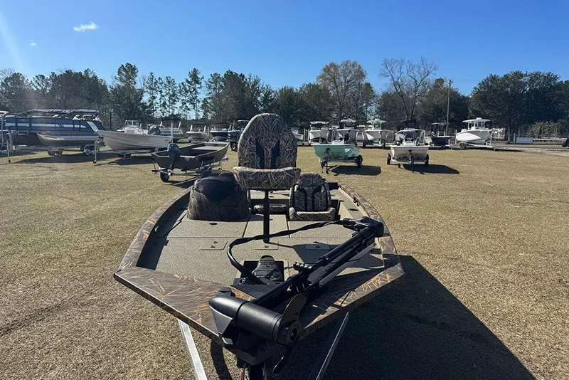 Slide: The Image of 2026 G3 Sportsman 1710 boat on display in a sunny outdoor showroom. - 9