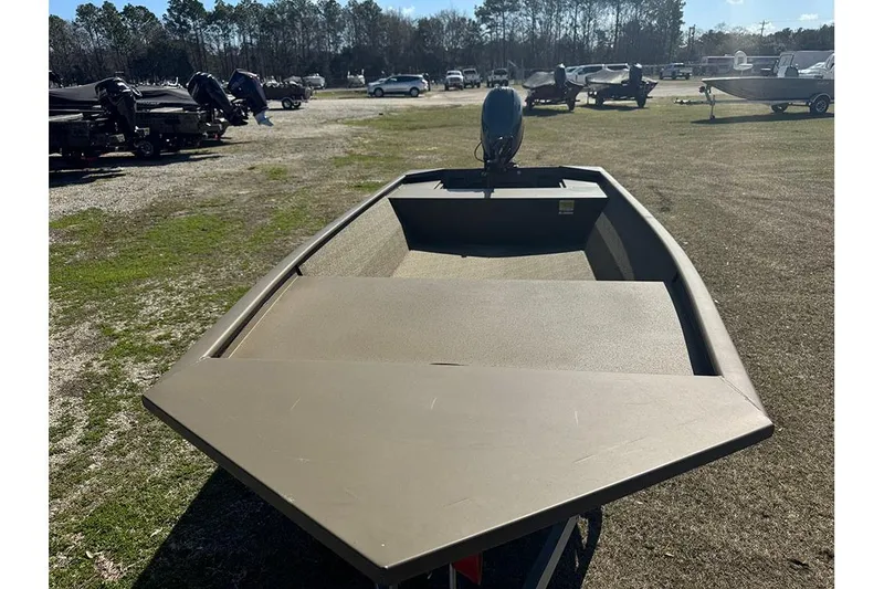 Slide: The Image of 2026 G3 Gator Tough 1652 VBW boat on grassy lot, rear view. - 10