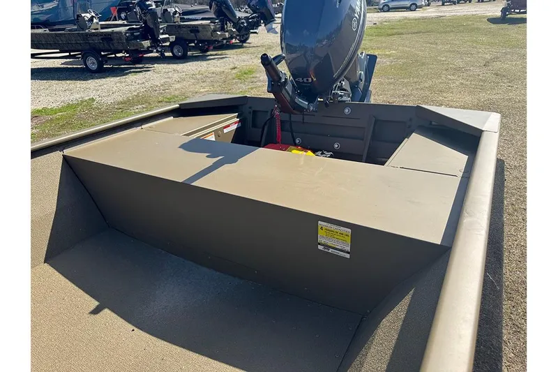 Slide: The Image of 2026 G3 Gator Tough 1652 VBW boat with outboard motor, parked on grass. - 13