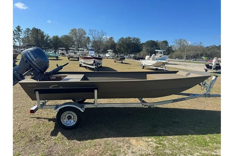 Slide: The Image of 2026 G3 Gator Tough 1652 VBW boat on trailer, parked outdoors under clear sky. - 7