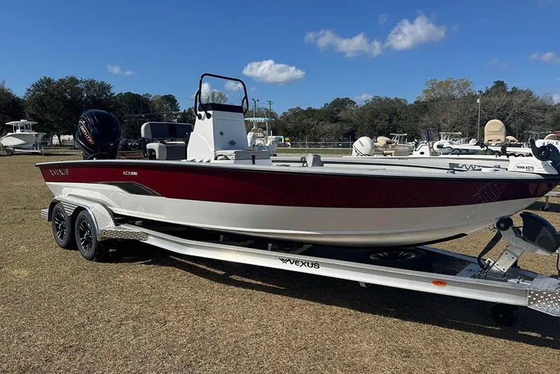 The Image of 2026 Vexus ACX 2210 boat on trailer, parked outdoors under clear blue sky. - 1