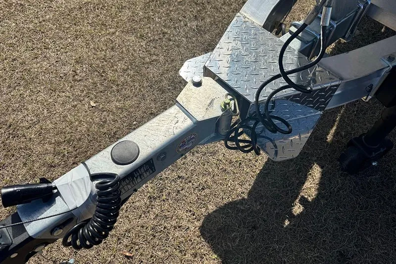 Slide: The Image of Trailer hitch of 2026 Vexus ACX 2210 on grass, featuring coiled cables and metal plating. - 10