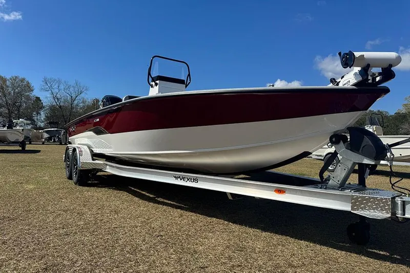 Slide: The Image of 2026 Vexus ACX 2210 boat on trailer, parked on grass under clear blue sky. - 12