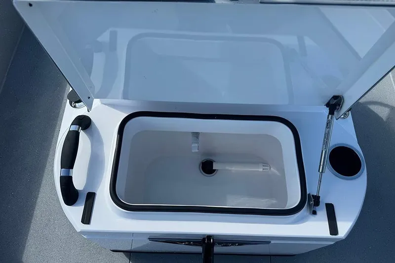 Slide: The Image of Open storage compartment in 2026 Vexus ACX 2210 boat, featuring a handle and cup holder. - 29