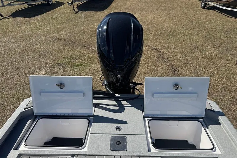 Slide: The Image of 2026 Vexus ACX 2210 boat with open storage compartments and outboard motor. - 43