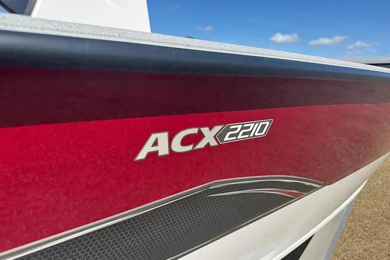 Slide: The Image of 2026 Vexus ACX 2210 boat with red and white design under blue sky. - 46