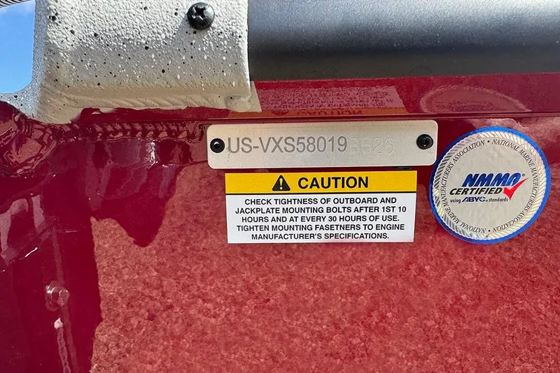 Slide: The Image of 2026 Vexus ACX 2210 caution label and certification sticker on red surface. - 47