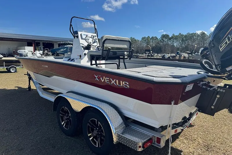 Slide: The Image of 2026 Vexus ACX 2210 boat on trailer, red and white design, parked outdoors. - 7