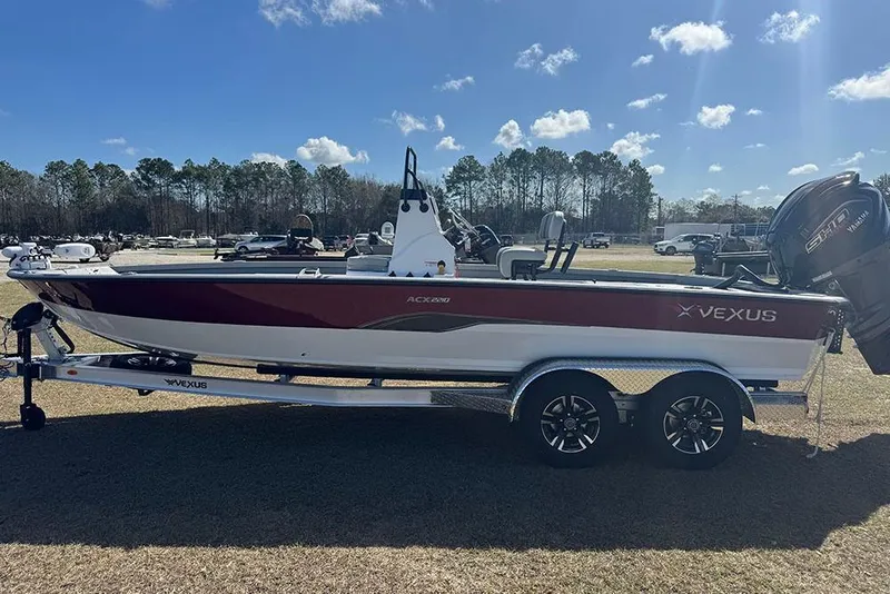 Slide: The Image of 2026 Vexus ACX 2210 boat on trailer under clear blue sky. - 8