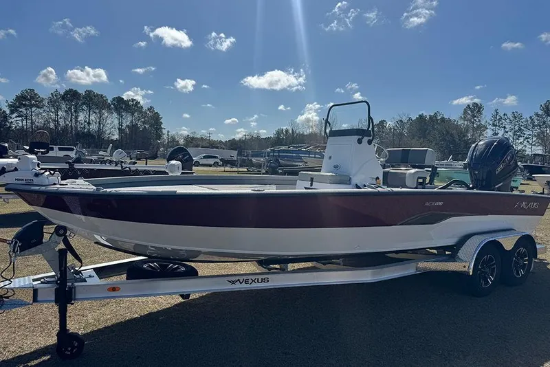 Slide: The Image of 2026 Vexus ACX 2210 boat on trailer under clear blue sky. - 9