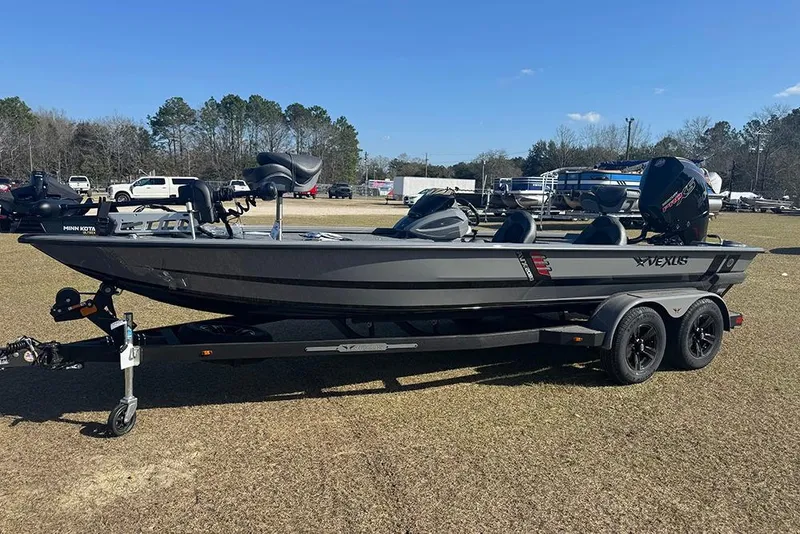 The Image of 2026 Vexus AVX 2080 boat on trailer, parked on grass under clear blue sky. - 1