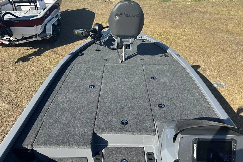 Slide: The Image of 2026 Vexus AVX 2080 boat deck with seating and equipment, parked on grass. - 12