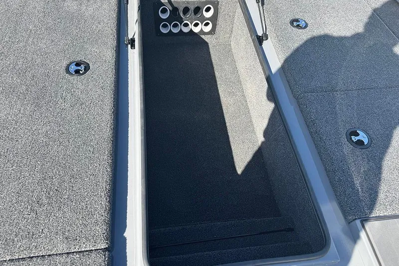 Slide: The Image of 2026 Vexus AVX 2080 boat storage compartment with carpeted interior and circular holders. - 15