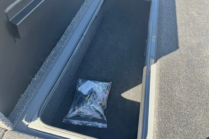 Slide: The Image of Storage compartment in 2026 Vexus AVX 2080 boat with a plastic bag inside. - 16