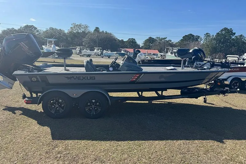 Slide: The Image of 2026 Vexus AVX 2080 boat on trailer, parked outdoors under clear blue sky. - 9