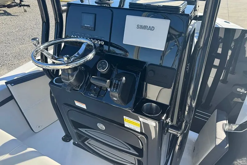 Slide: The Image of 2026 Sea Pro 202 Center Console boat dashboard with steering wheel and Simrad display. - 25