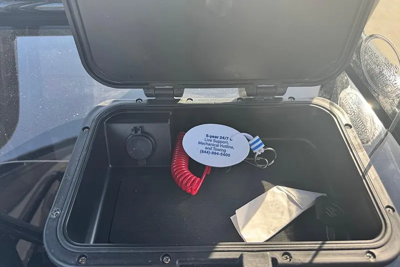 Slide: The Image of Open storage compartment in 2026 Sea Pro 202 Center Console boat with hotline keychain. - 27