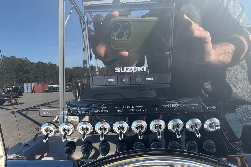 Slide: The Image of Control panel of a 2026 Sea Pro 202 Center Console boat with Suzuki display. - 29
