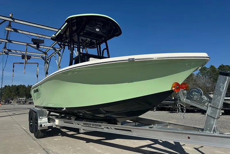 Slide: The Image of 2026 Sea Pro 202 Center Console boat on trailer, outdoors under clear blue sky. - 3