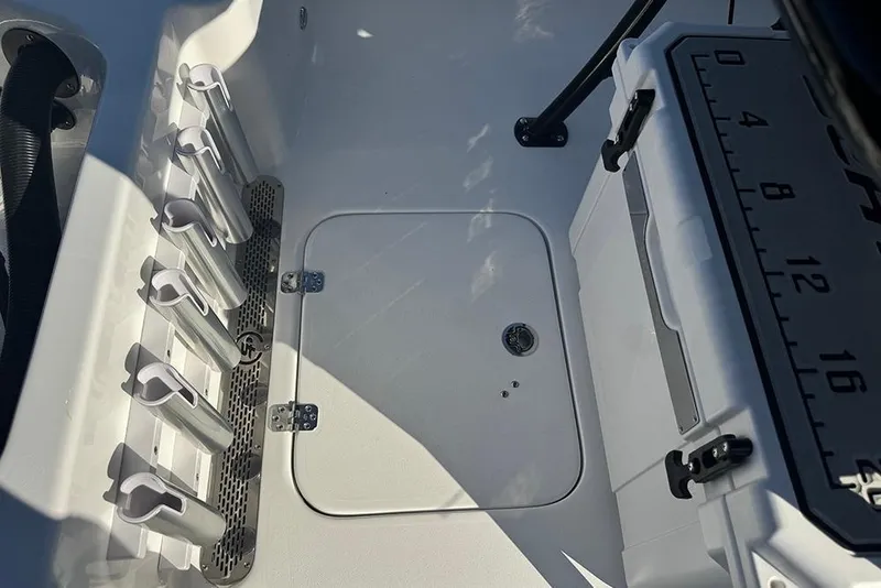 Slide: The Image of 2026 Sea Pro 202 Center Console boat interior with rod holders and storage compartment. - 36