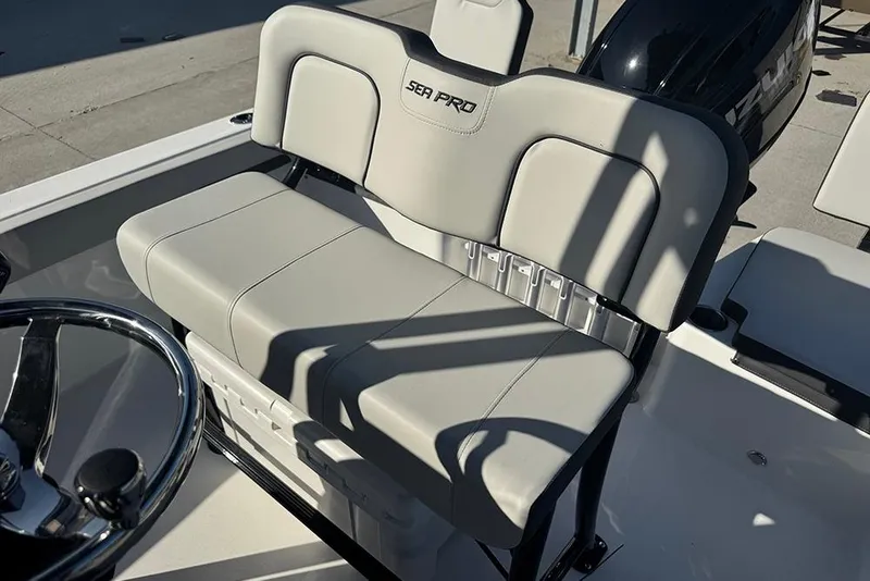 Slide: The Image of 2026 Sea Pro 202 Center Console boat seat and steering wheel in sunlight. - 45