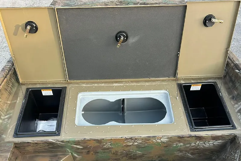 Slide: The Image of 2026 G3 Gator Tough 17 SC boat storage compartments with camouflage design and secure locks. - 9