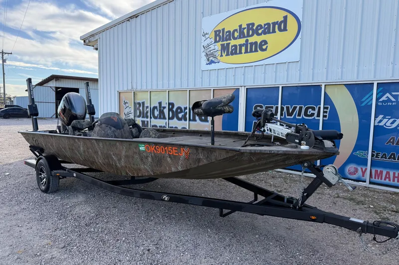 Slide: The Image of 2023 G3 Sportsman 1910 boat at BlackBeard Marine dealership, featuring camouflage design. - 2