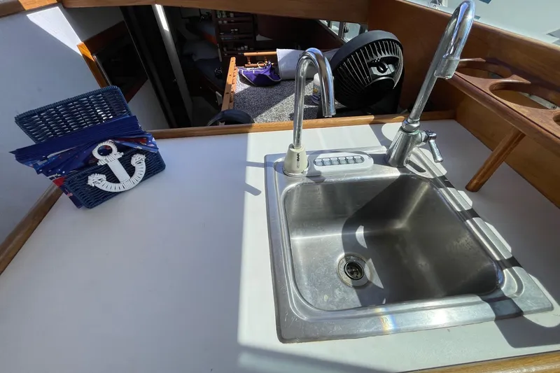 Slide: The Image of 1975 Uniflite Sport Fisher 42 boat interior with sink and nautical decor. - 15