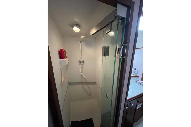 Slide: The Image of 1975 Uniflite Sport Fisher 42 yacht shower with glass door and modern fixtures. - 21