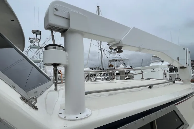 Slide: The Image of 1975 Uniflite Sport Fisher 42 boat deck with crane, marina background. - 22