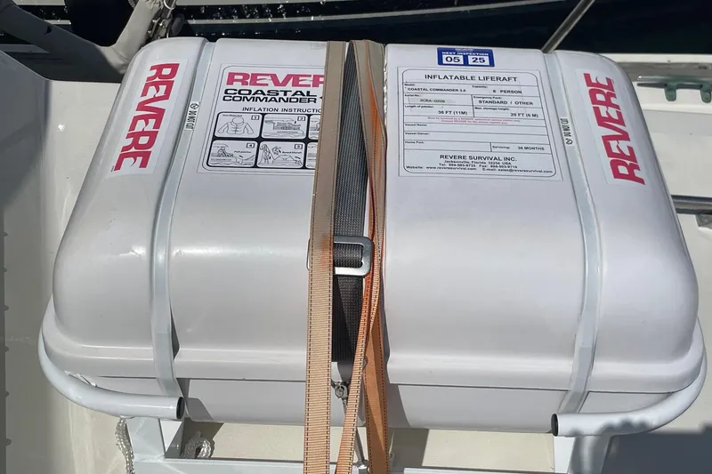 Slide: The Image of Inflatable liferaft on 1975 Uniflite Sport Fisher 42, secured with straps, labeled "Revere." - 24