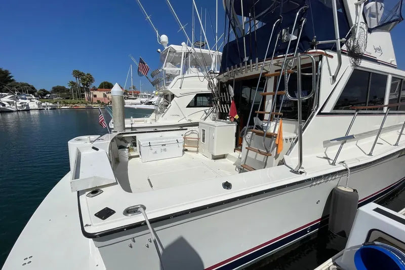Slide: The Image of 1975 Uniflite Sport Fisher 42 docked, featuring spacious deck and fishing equipment. - 27