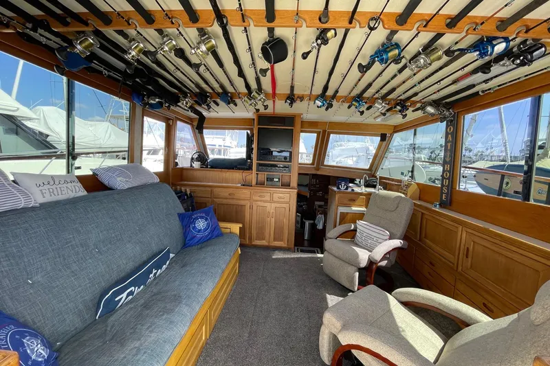 Slide: The Image of Interior of a 1975 Uniflite Sport Fisher 42 with fishing rods and cozy seating. - 3