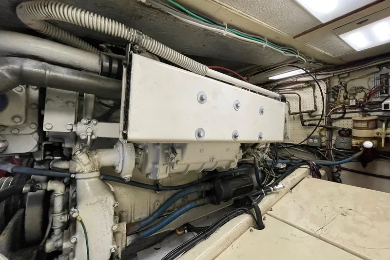 Slide: The Image of Engine room of a 1975 Uniflite Sport Fisher 42, showcasing mechanical components and wiring. - 30