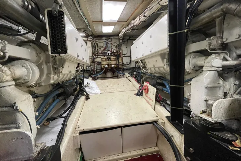 Slide: The Image of Engine room of a 1975 Uniflite Sport Fisher 42, showcasing dual engines and mechanical components. - 31