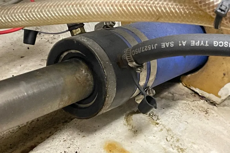 Slide: The Image of Close-up of a 1975 Uniflite Sport Fisher 42 boat's shaft and hose connections. - 32
