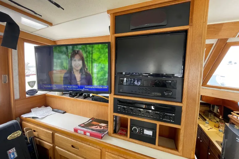 Slide: The Image of 1975 Uniflite Sport Fisher 42 interior with TV and audio system setup. - 4