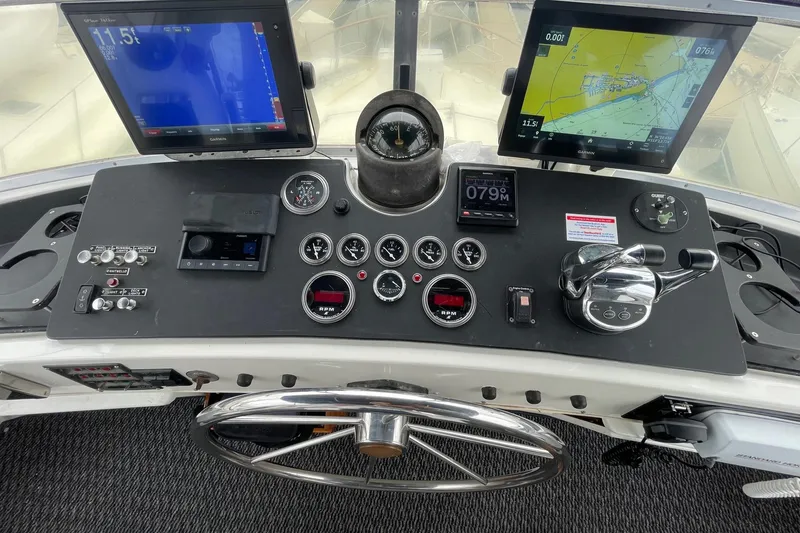 Slide: The Image of Cockpit of 1975 Uniflite Sport Fisher 42 with navigation screens and controls. - 9