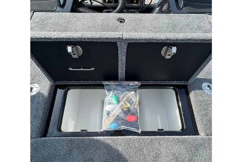 Slide: The Image of Open storage compartment in 2026 Phoenix 921 Elite X boat with accessories. - 18