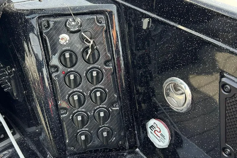 Slide: The Image of Control panel of 2026 Phoenix 921 Elite X boat with switches and labels. - 20