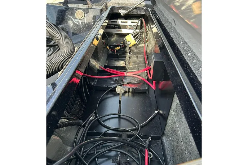 Slide: The Image of Interior view of 2026 Phoenix 921 Elite X boat showing wiring and battery setup. - 21