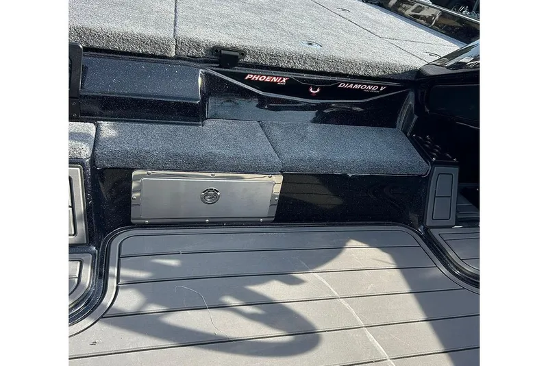 Slide: The Image of 2026 Phoenix 921 Elite X boat interior with carpeted deck and storage compartment. - 22